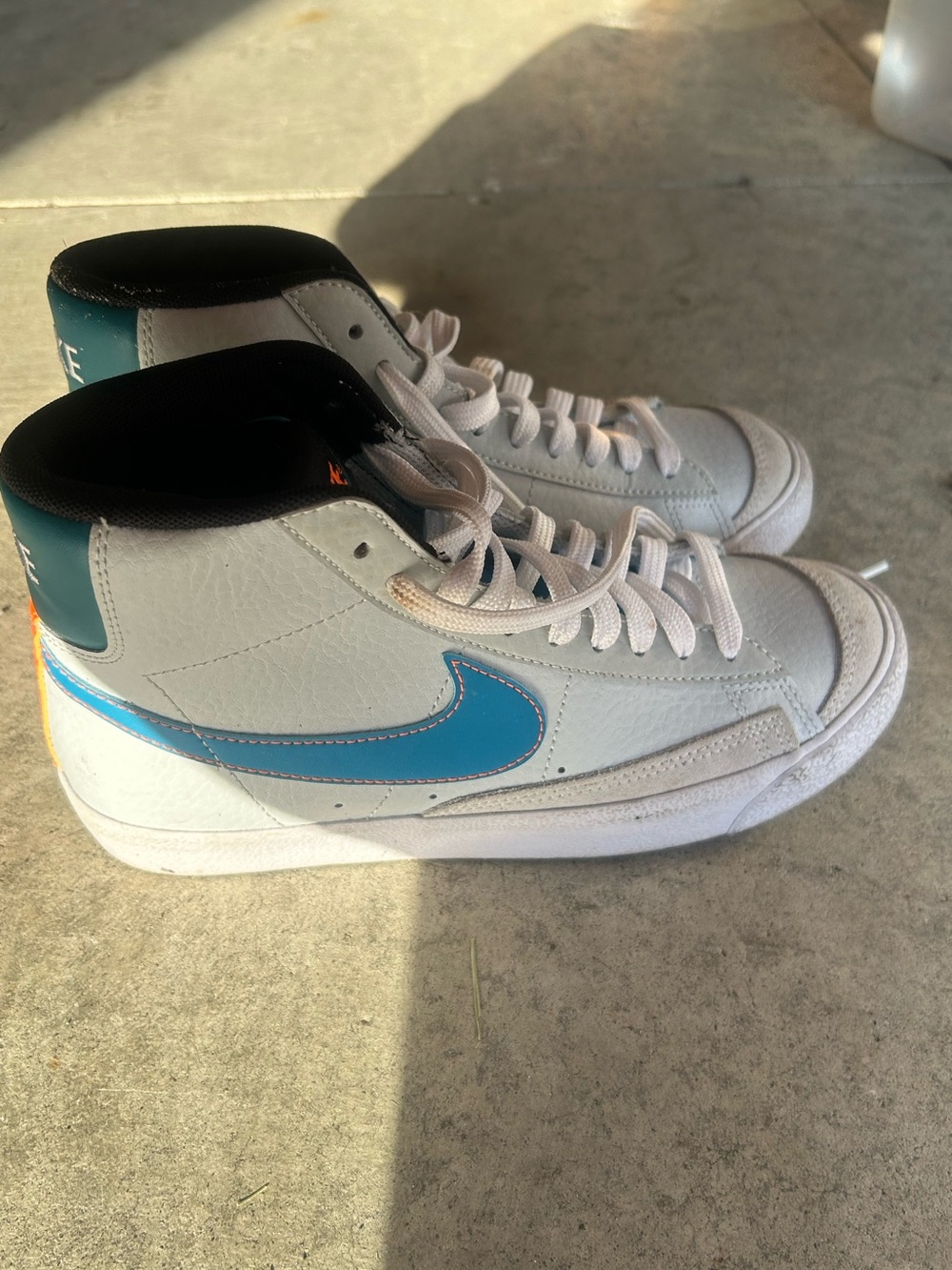 Nike White High-Top Sneakers with Blue Swoosh